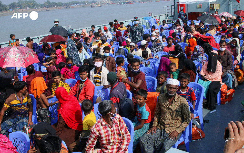 Rohingya refugees board a Bangladesh Navy ship to be transported to the island of Bhashan Char in Chittagong.  Bangladesh has begun transferring Rohingya refugees to a low-lying island in an area prone to cyclones and floods, with rights groups alleging people are being coerced