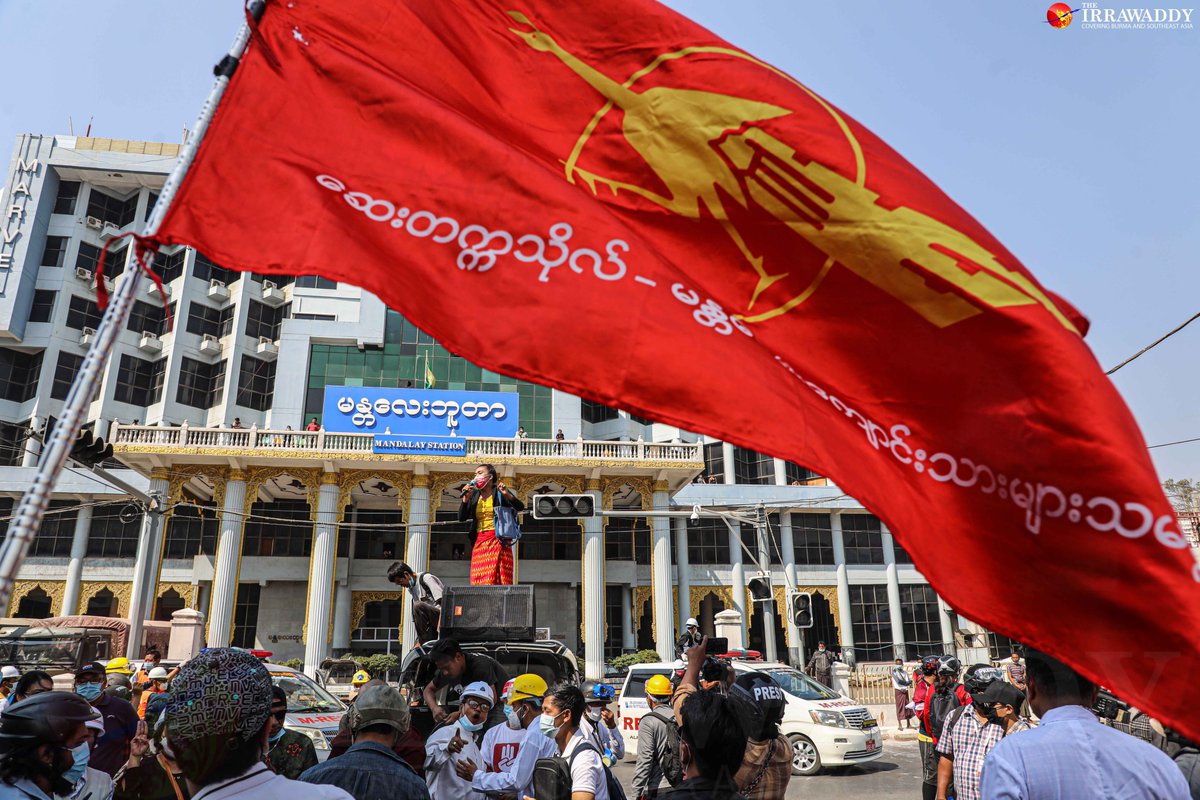 Anti_coup protesters filled the streets of Mandalay on Monday, standing in front of government offices and banks and urging staff to join the #CivilDisobedienceMovement, despite the presence of troops. (Photo: The Irrawaddy) 