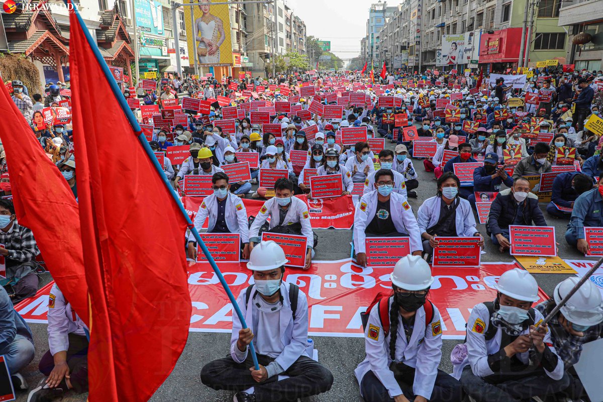 Anti_coup protesters filled the streets of Mandalay on Monday, standing in front of government offices and banks and urging staff to join the #CivilDisobedienceMovement, despite the presence of troops. (Photo: The Irrawaddy) 