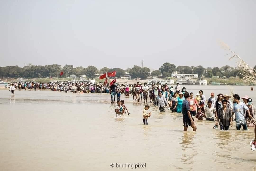 Riot police blocked the entrance to the city of Monywa to disperse the protestor crowds but people protest in Chindwin River outside the city without taking a step back