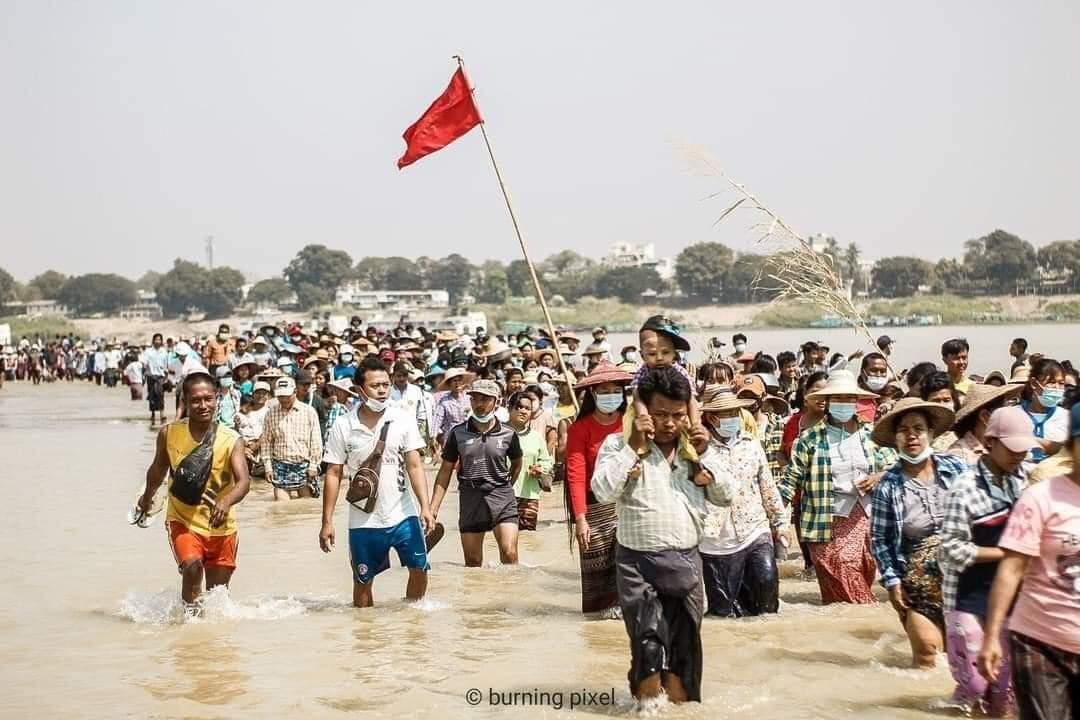 Riot police blocked the entrance to the city of Monywa to disperse the protestor crowds but people protest in Chindwin River outside the city without taking a step back