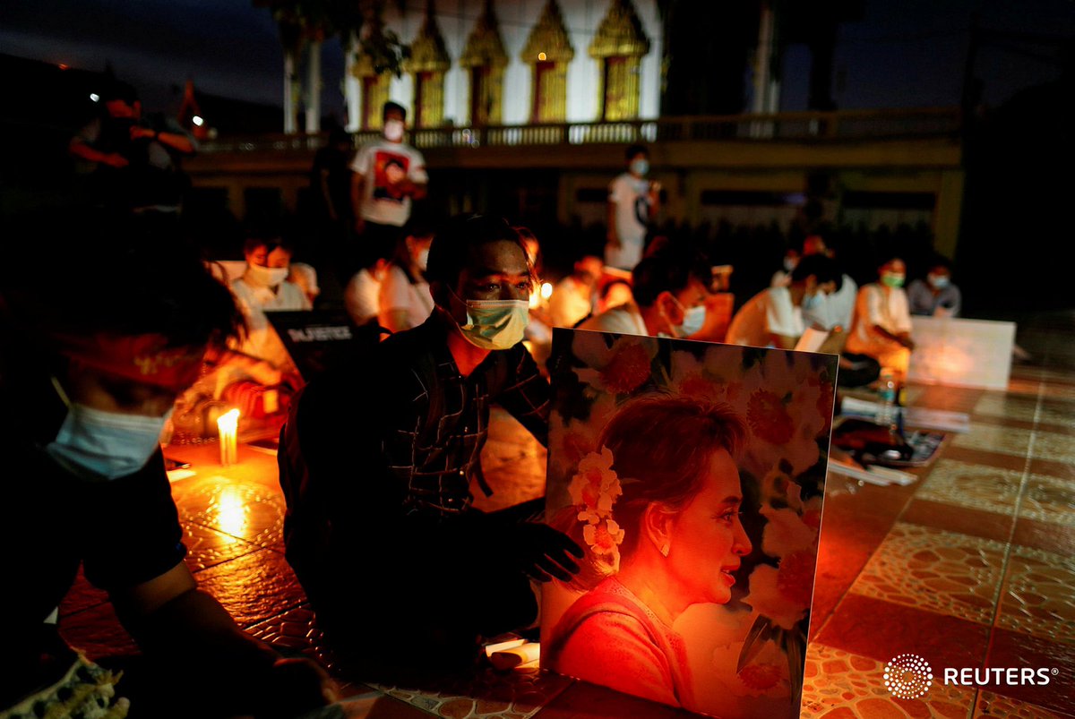 A migrant protesting against the military junta in Myanmar holds a picture of leader Aung San Suu Kyi, during a demonstration in Bangkok, Thailand, March 28, 2021. REUTERS/Jorge Silva
